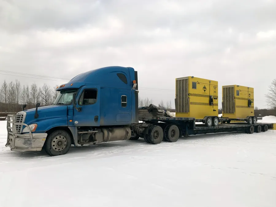 Heated ESU trailers shipped by flatbed semi in Canadian winter